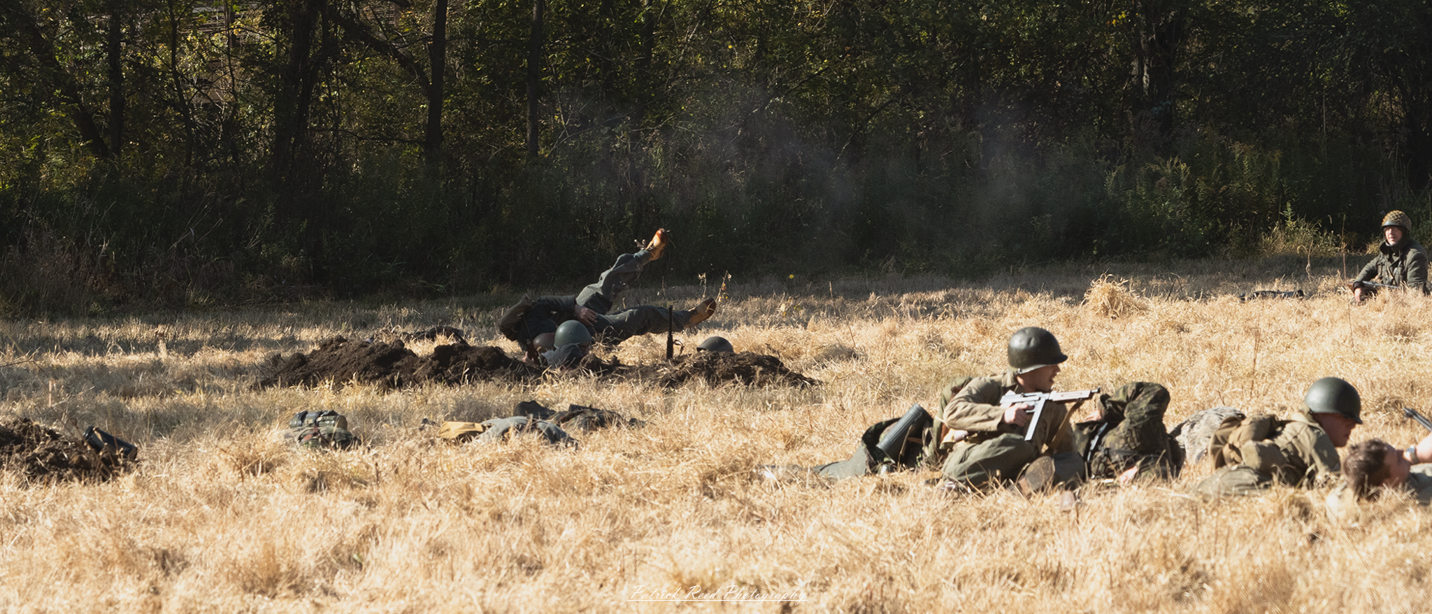 "WW2 battlefield scene depicting the chaos and intensity of warfare. Soldiers in period uniforms are engaged in combat, taking cover behind makeshift barriers and debris. Smoke rises in the background, and the landscape is littered with remnants of battle, such as discarded weapons and equipment. The sky is overcast, adding to the somber atmosphere of the battlefield. This image captures the bravery, struggle, and harsh realities faced by soldiers during World War II."
